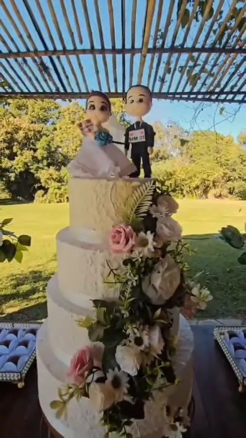 Bolo de casamento com flores e topo dos noivos